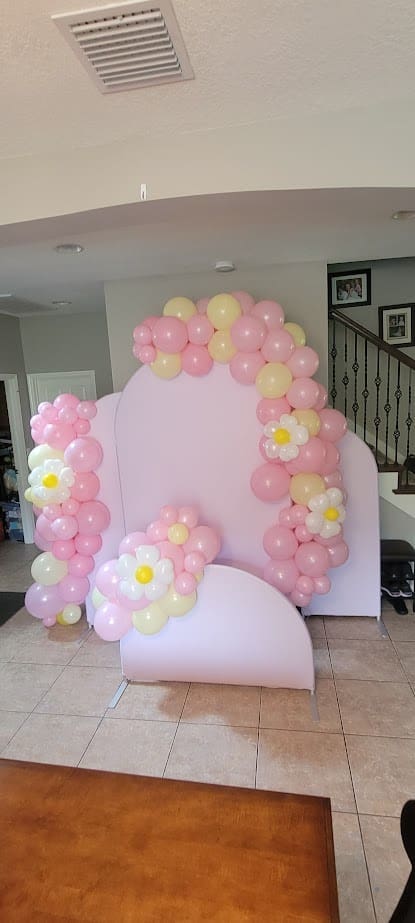 pink and yellow chiara wall arch backdrop with flowers