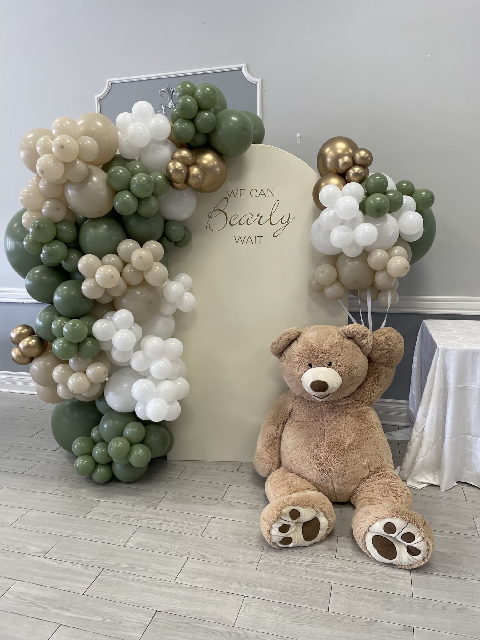 chiara wall arch backdrop with a teddy bear