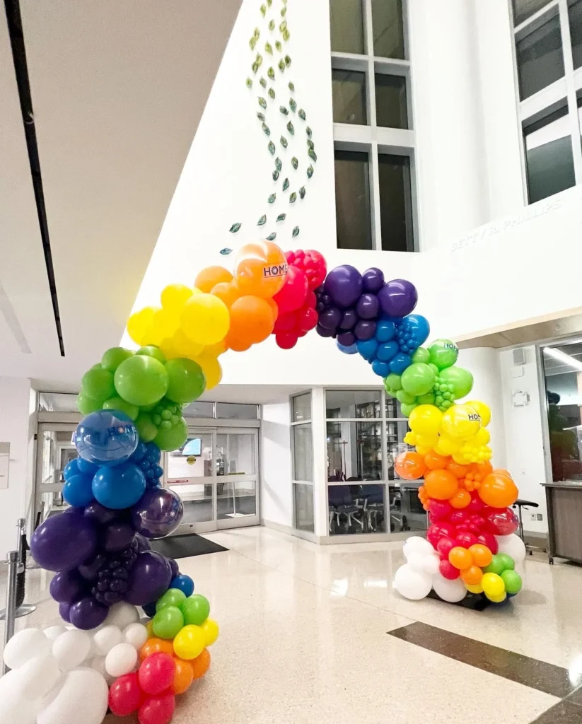 colorful corporate balloon arch inside of building