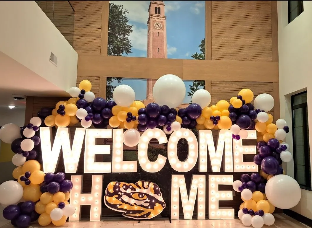 welcome home light up marquee with a balloon arch