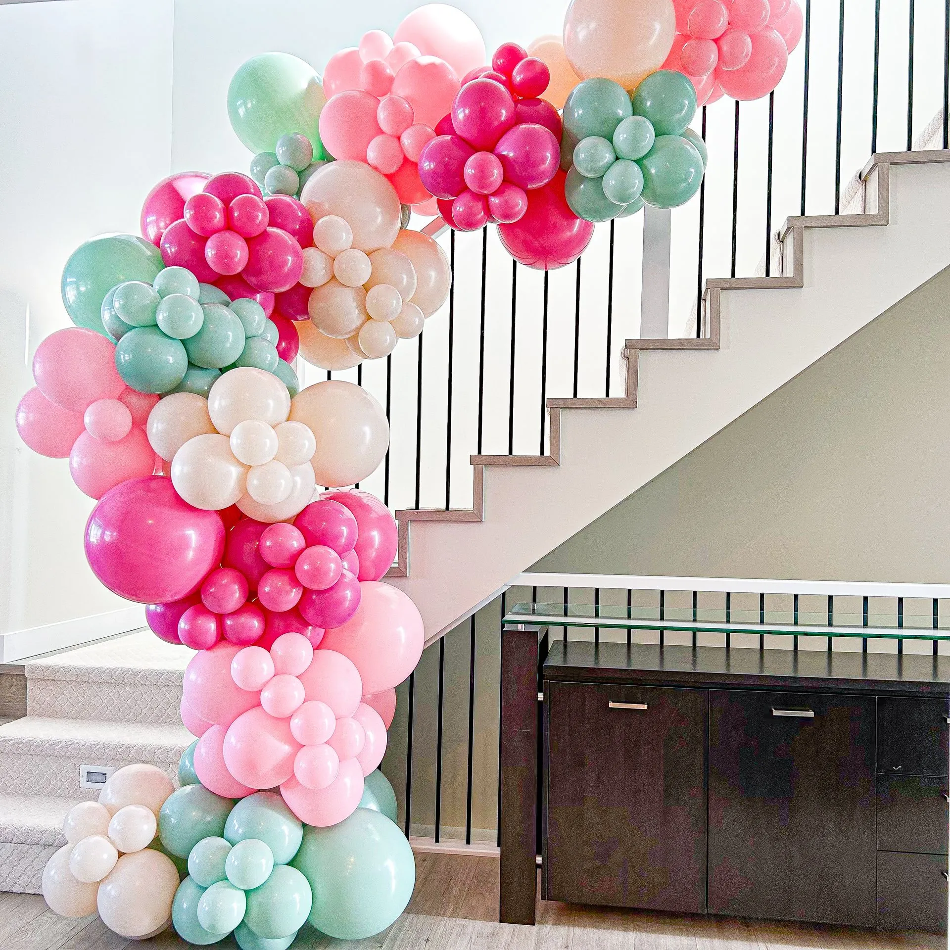 balloon garland on indoor railing of steps