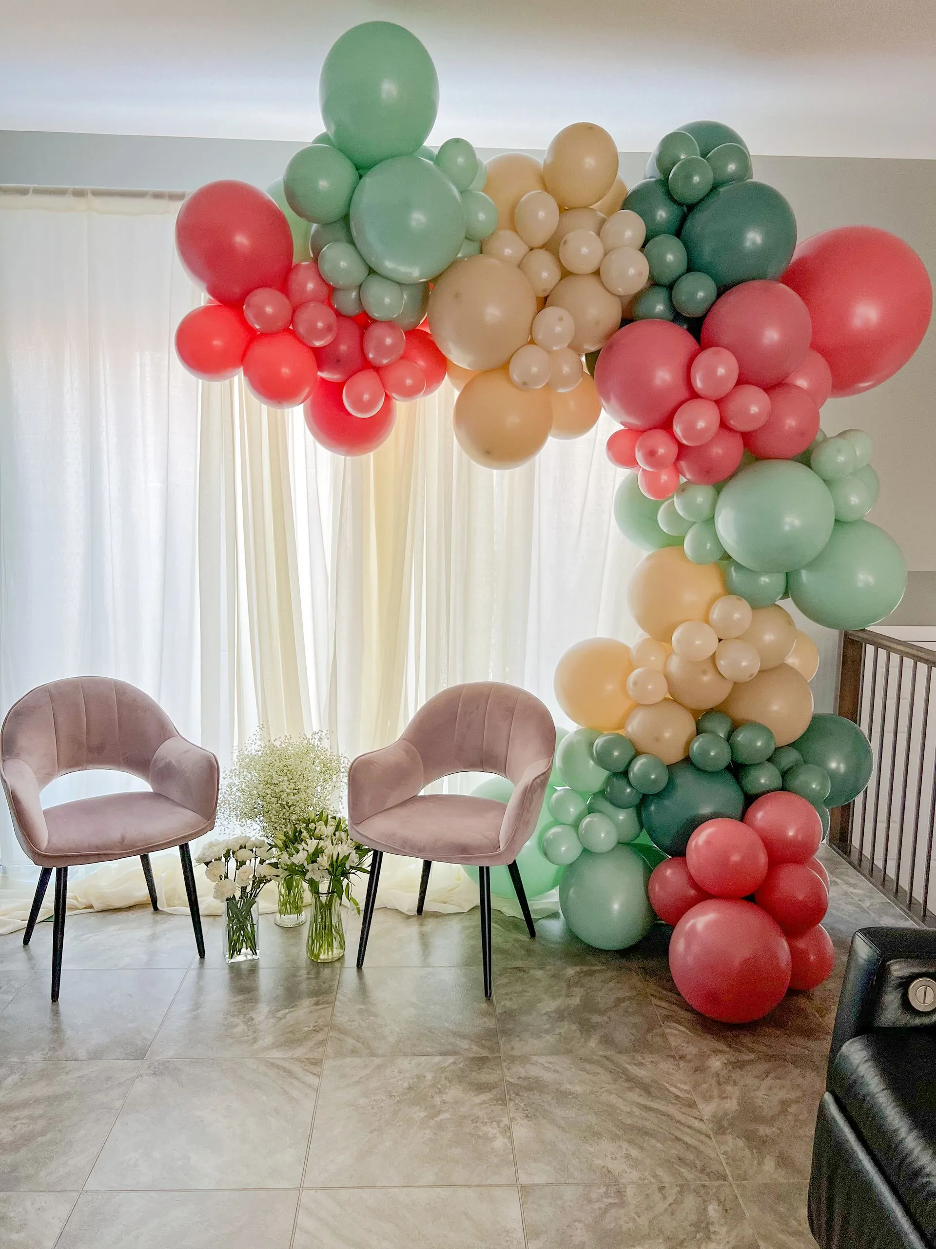 balloon garland with beige, pinks, and green colors