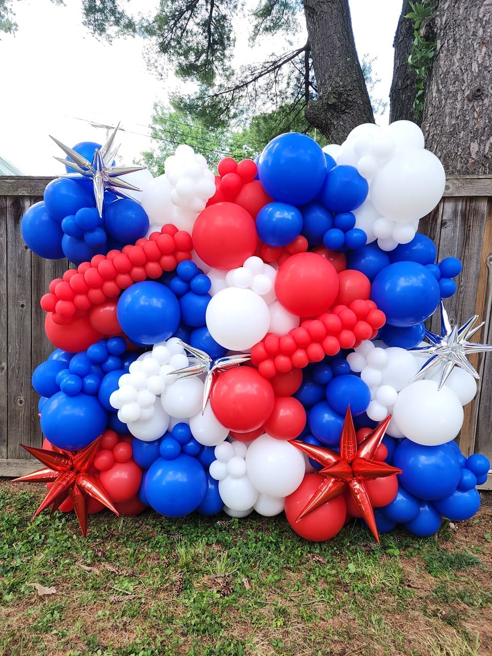 red, white, and blue balloon wall