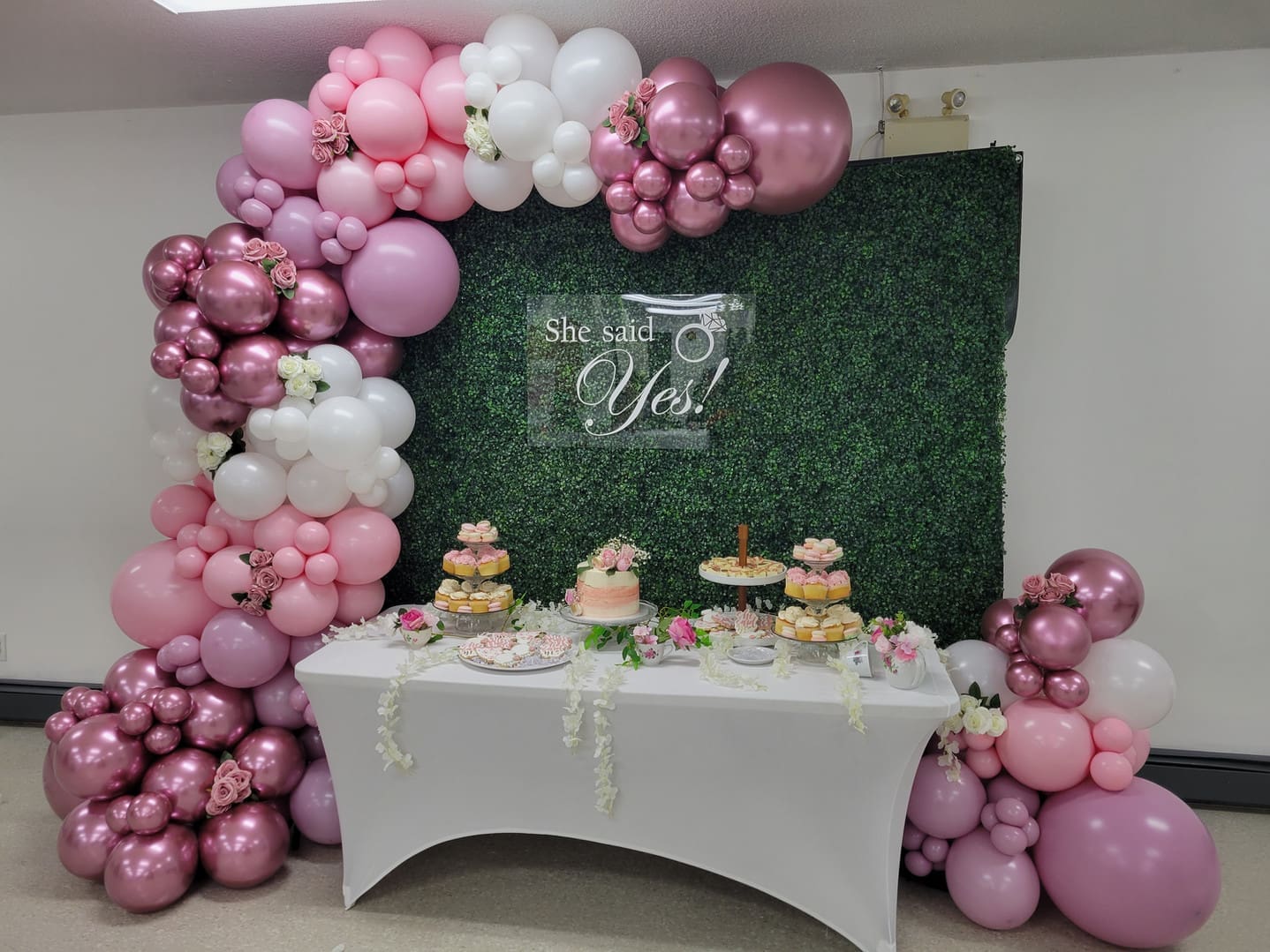 pink and white balloon garland celebrating an engagement