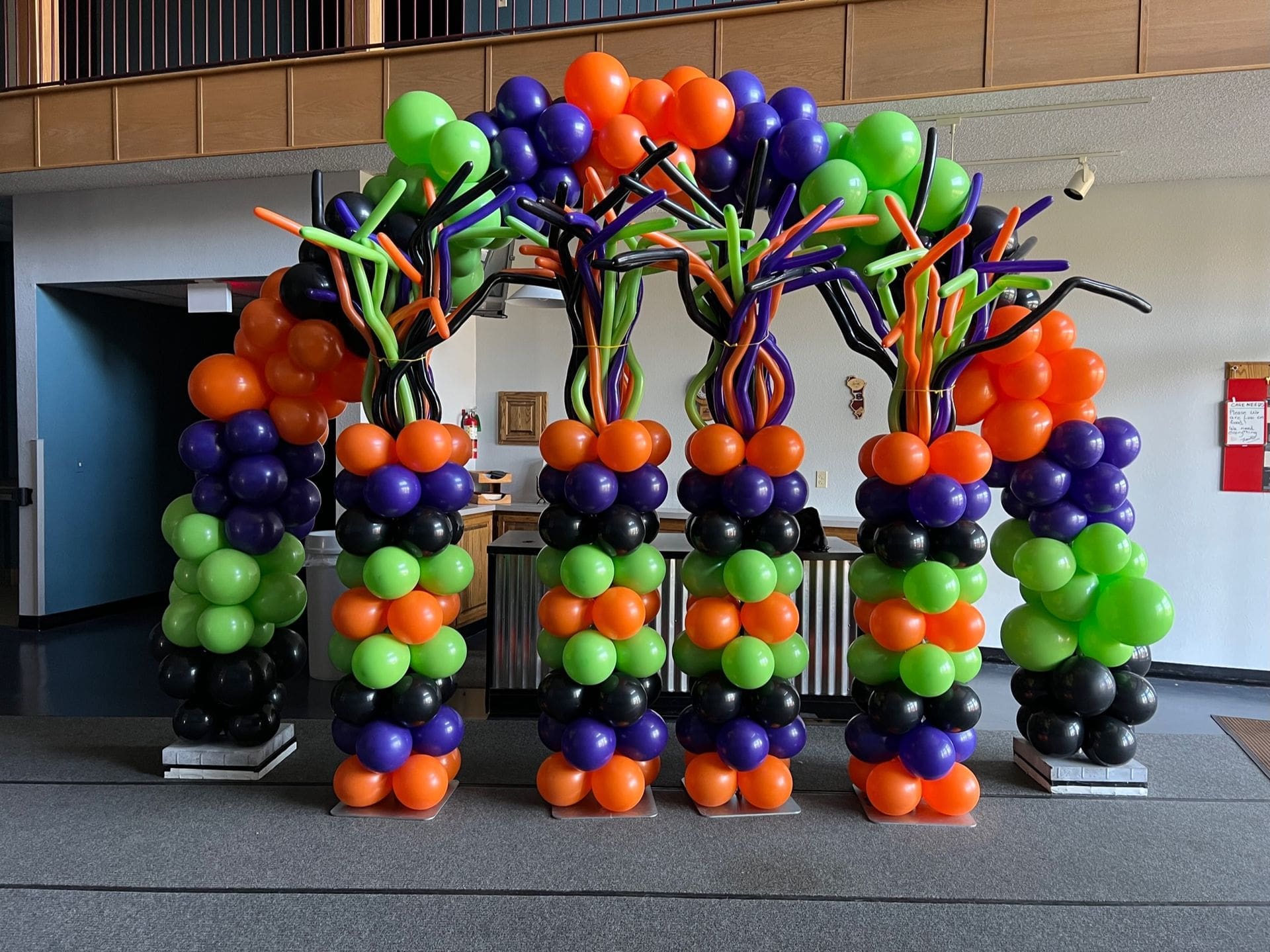 A balloon arch with 4 balloon columns under it