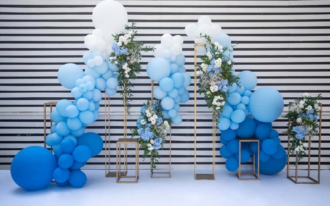 decor with balloons of white, blue and flower arrangemets. Party decorations.