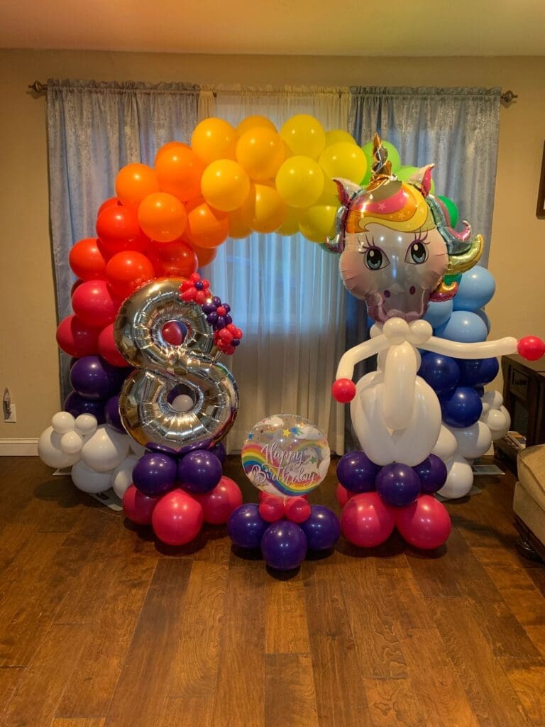 unicorn+in+front+of+a+rainbow+balloon+arch
